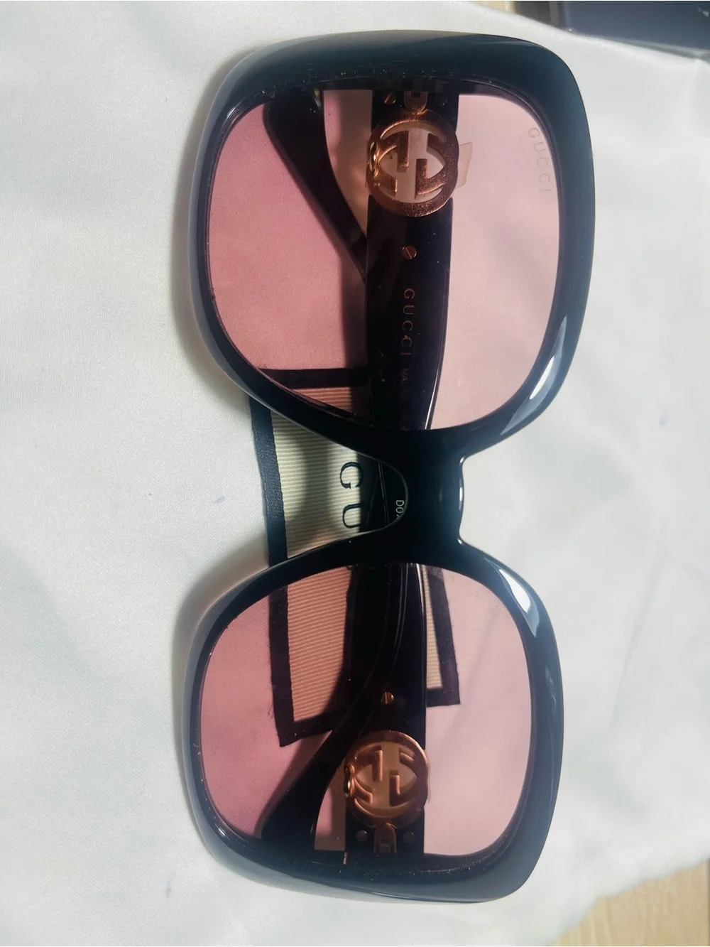 Gucci Black Frame Sunglasses with Pink Lenses and Gold Logo Accent